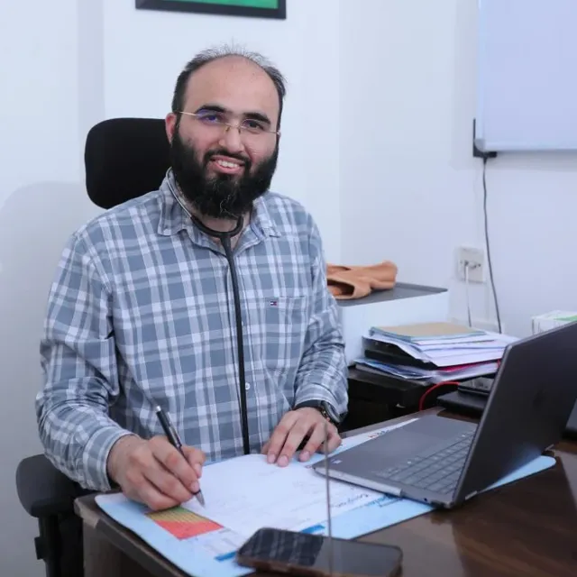 Dr Khizer Hussain Junaidy at his desk at Caspian Healthcare